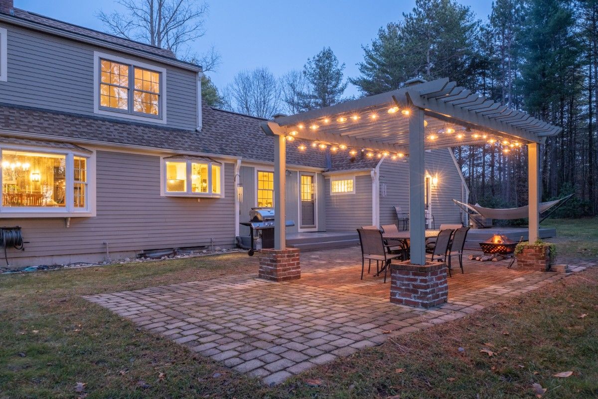 Backyard patio cover idea with pergola and string lighting