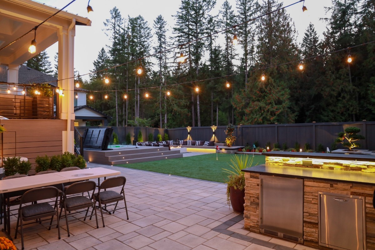 Outdoor kitchen surrounded by Pacific Northwest landscaping with stone hardscaping 