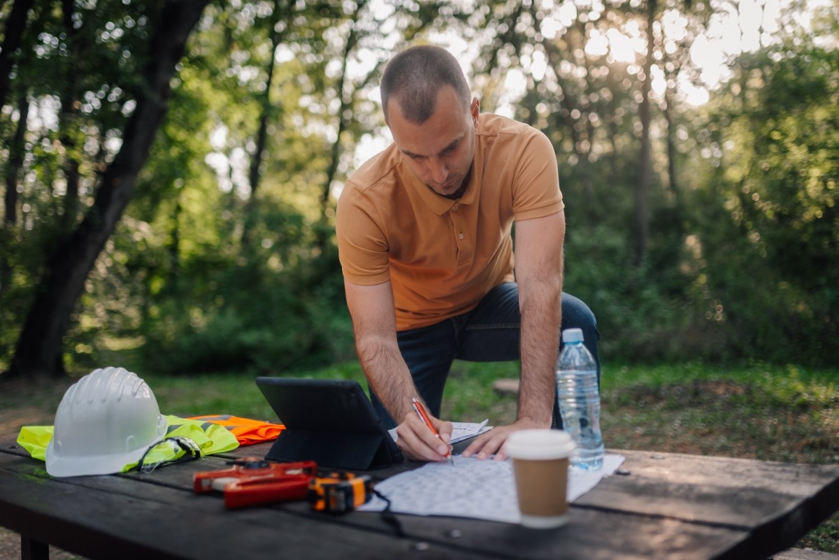 Landscape architect drafting construction plans for an outdoor living project