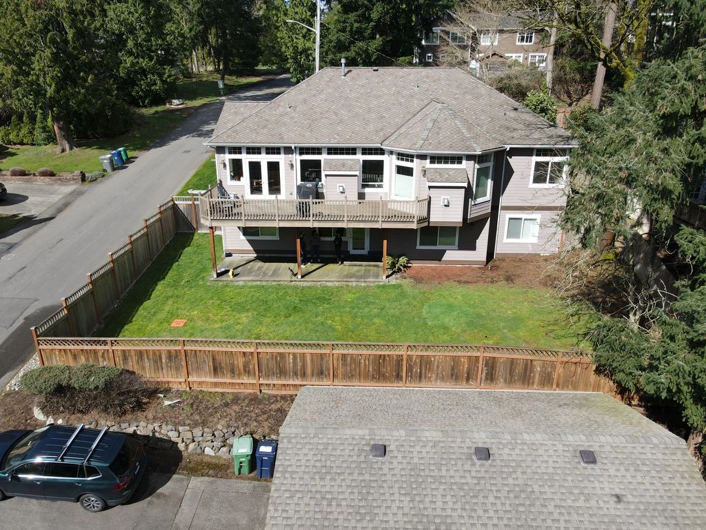 Bare backyard with patchy grass before redesign