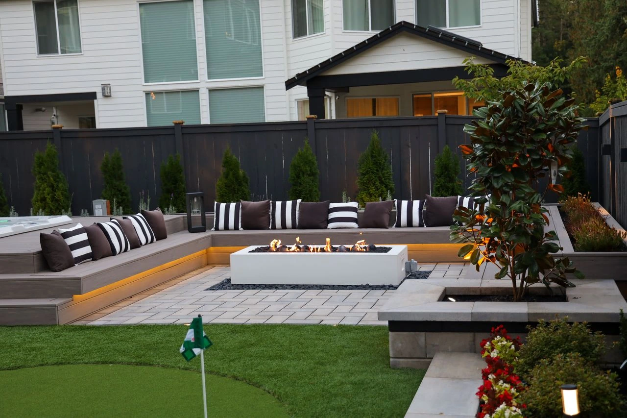 Sunken patio with custom pavement designed by Angkorscape seating area and fire pit