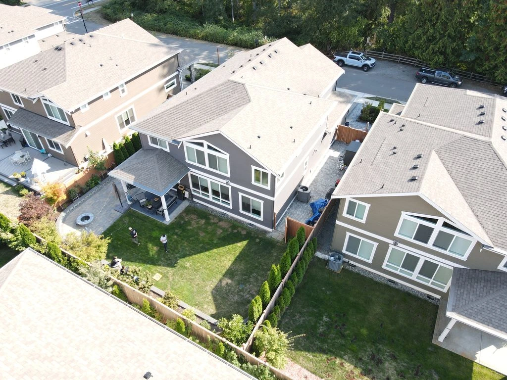 Aerial view of a Newcastle residential backyard with sparse lawn and basic landscaping before the project.