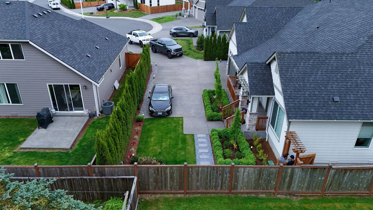 Issaquah after aerial house driveway parked cars landscaped shrubs lawn