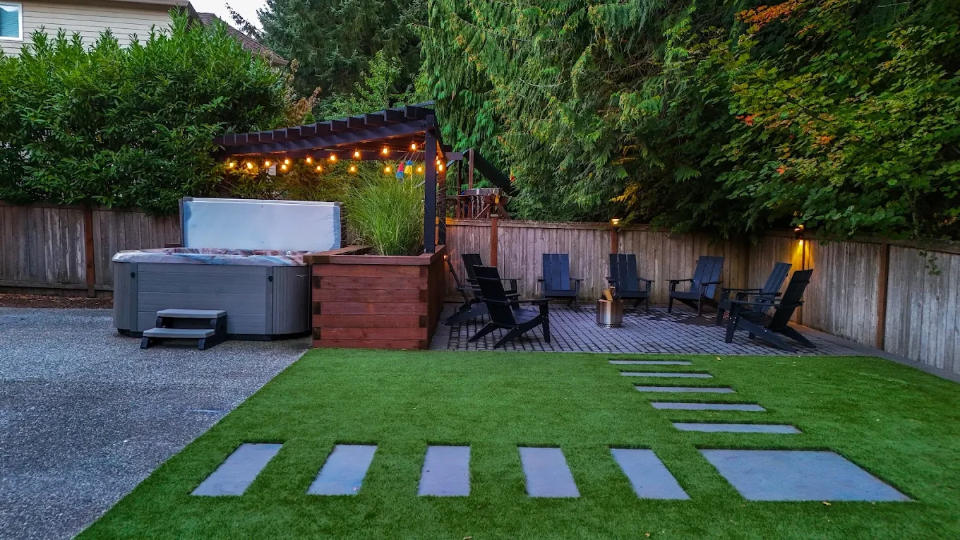 Issaquah backyard hot tub string lights stepping stones evening