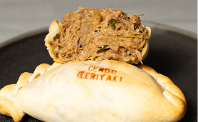 Empanada with 'CENDO TERIYAKI' text stamped on golden crust and visible shredded filling inside.