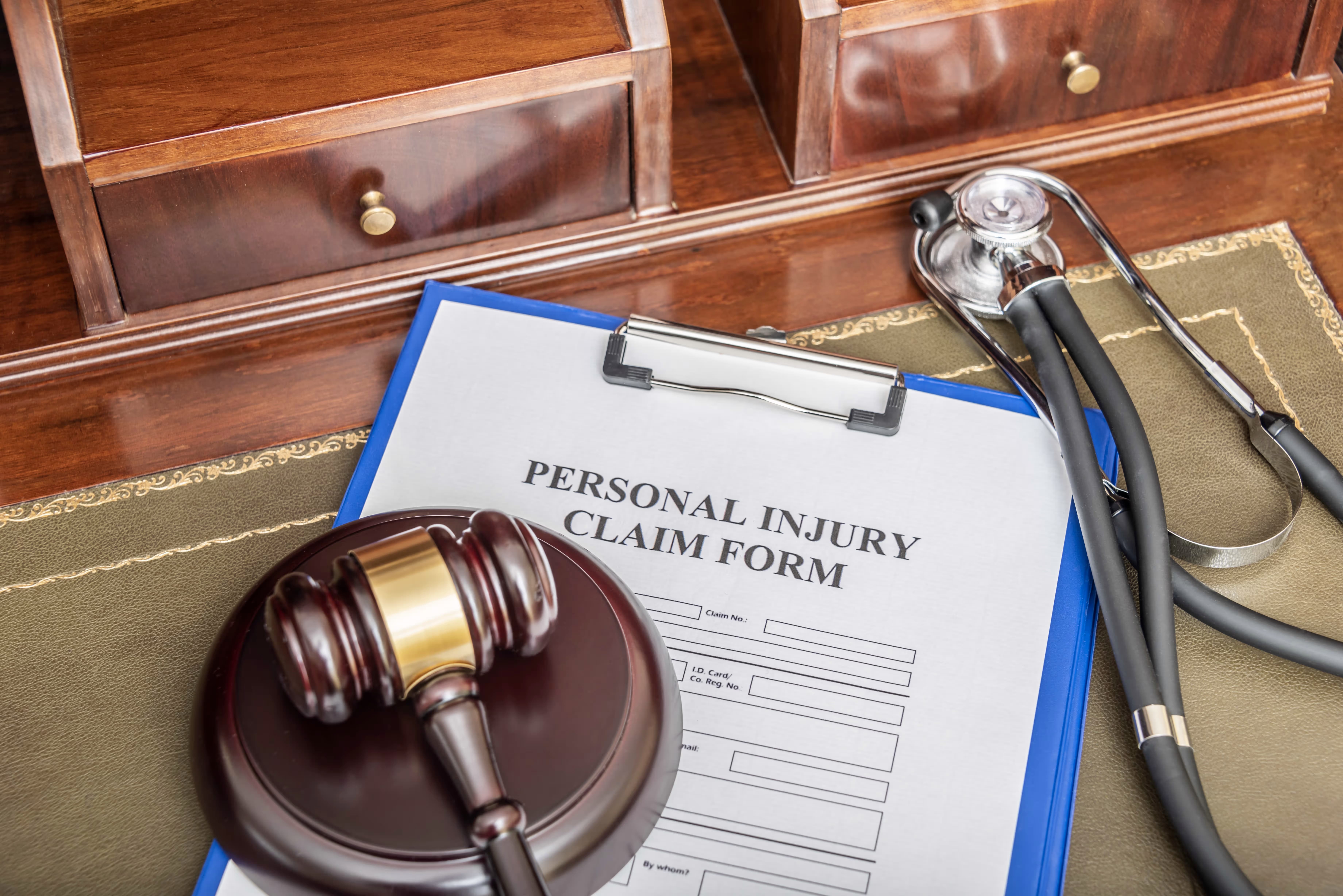 Legal professionals reviewing medical records on a desk with case files, illustrating the use of medical records in bodily injury litigation.