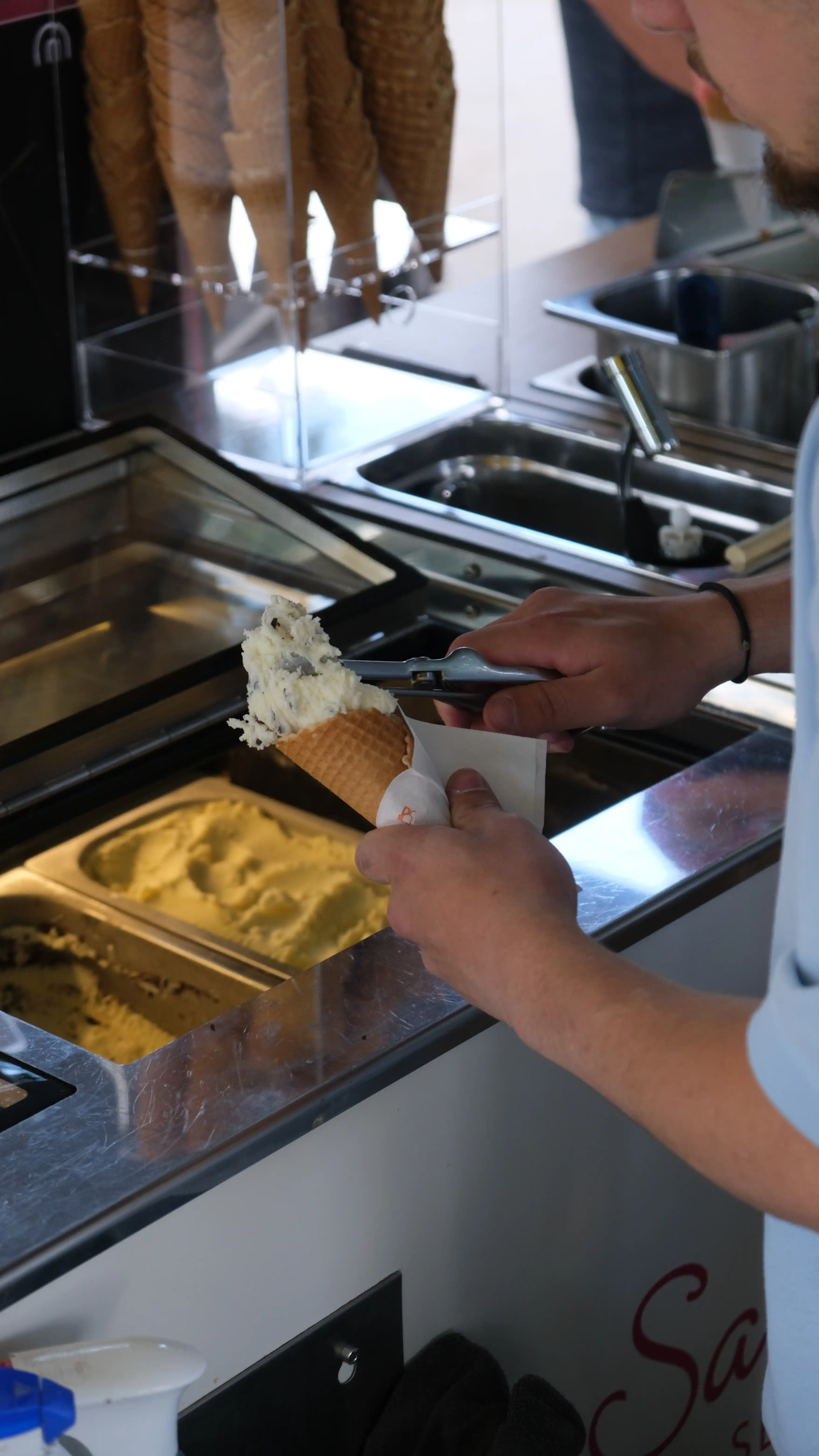 Hände schöpfen Eis am Sarcletti-Wagen im Englischen Garten München