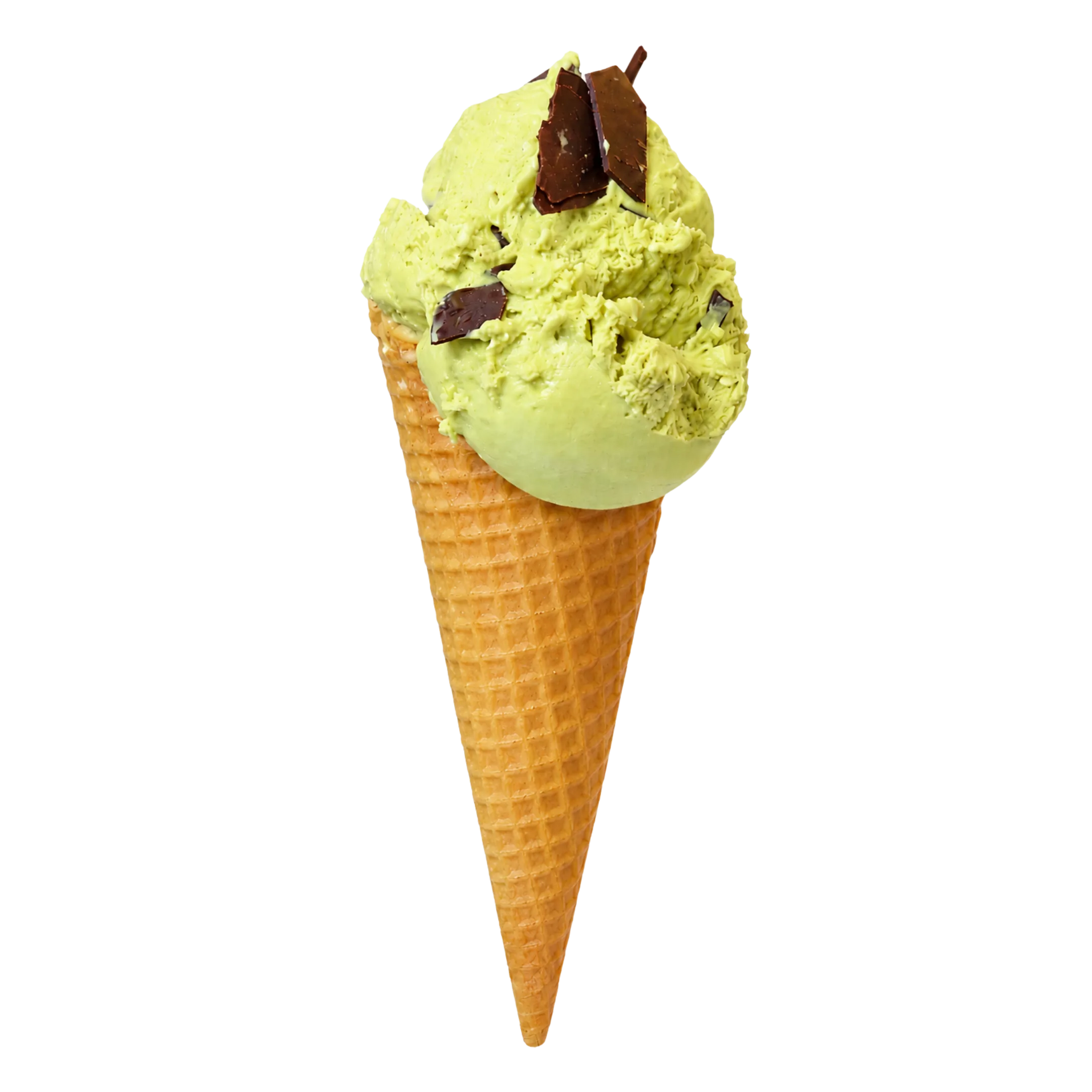 Green pistachio ice cream scoop with chocolate pieces on a waffle cone against black background.