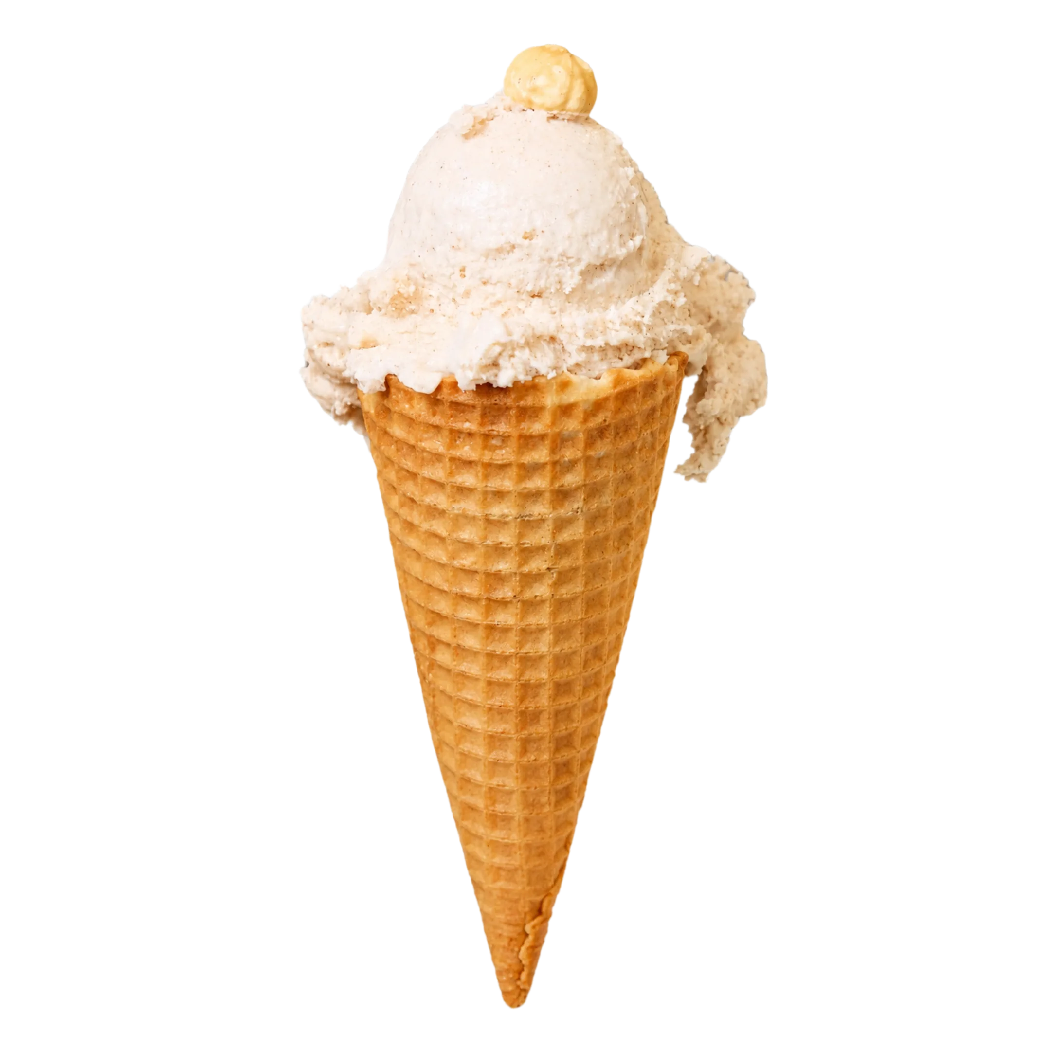 Single scoop of light brown cinnamon ice cream in a waffle cone with a small swirl on top.