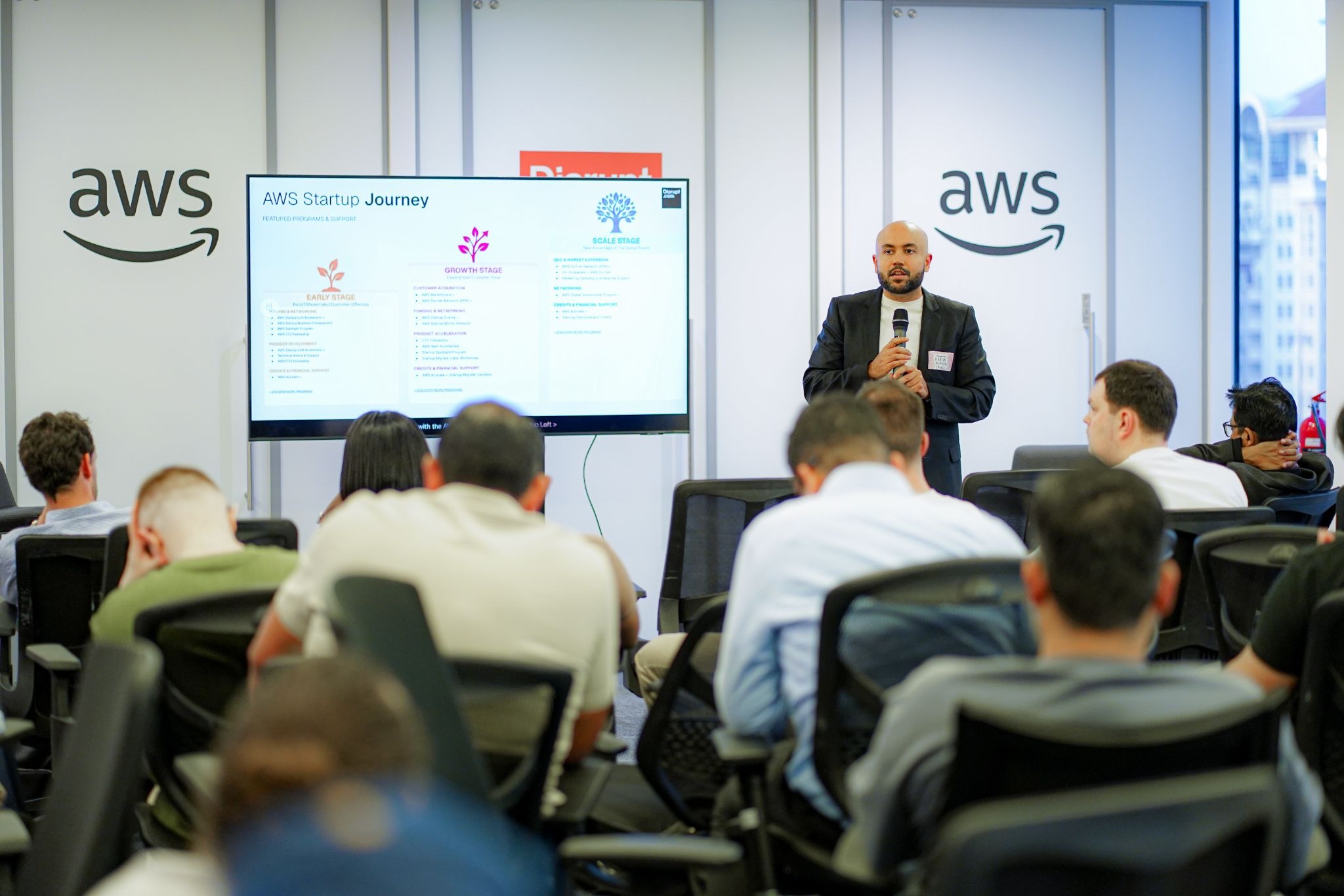 Karthik-Renjen-AWS-presenting-100000-dollar-startup-funding-credits-to-Disrupt-venture-studio-portfolio-companies-Dubai