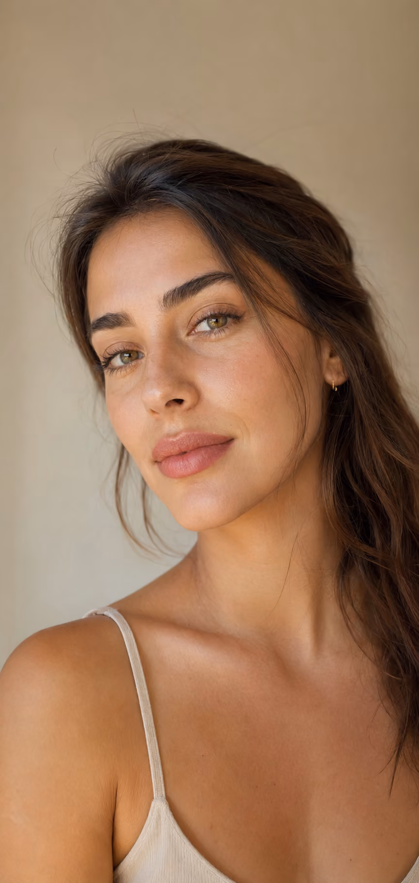 Close-up portrait of a woman with green eyes and long brown hair 