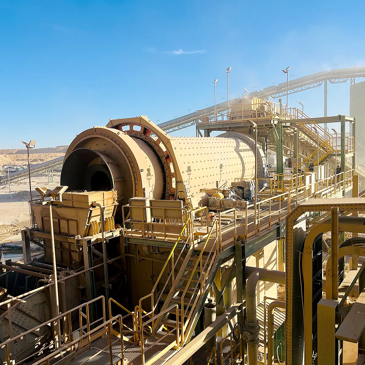 Industrial mining drum scrubber under clear blue sky.