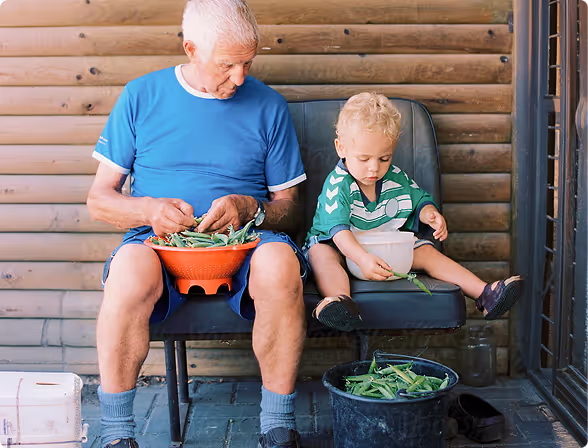 Grandfather and grandchild shelling peas