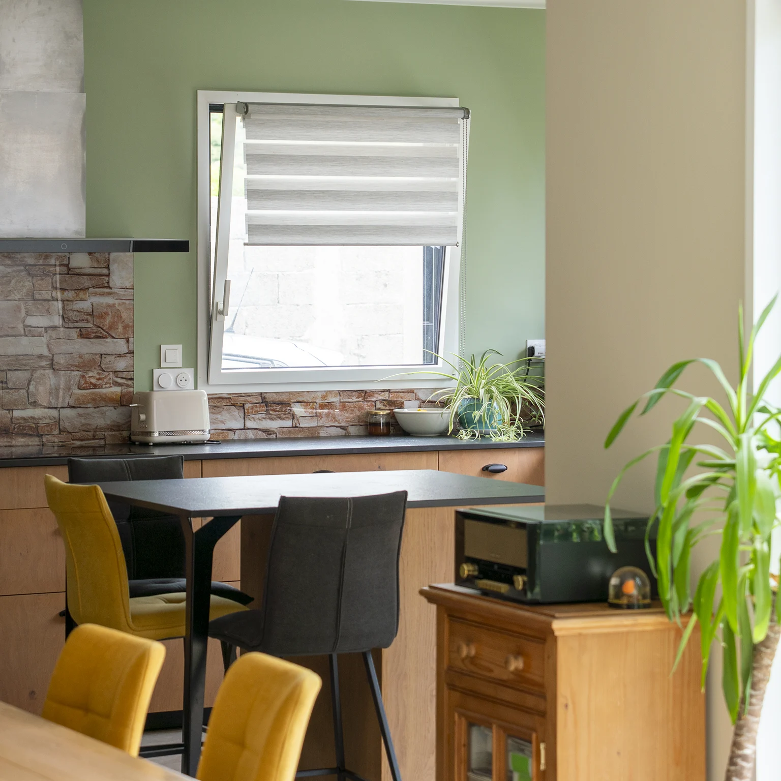 Coin cuisine avec mur vert sauge et crédence en briquettes