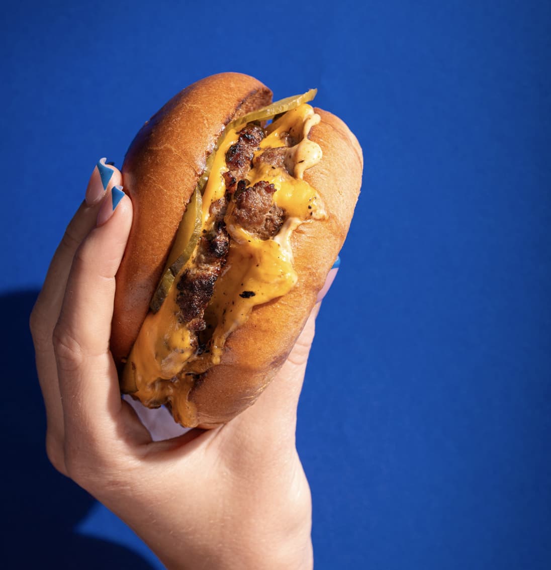 A delicious burger held high