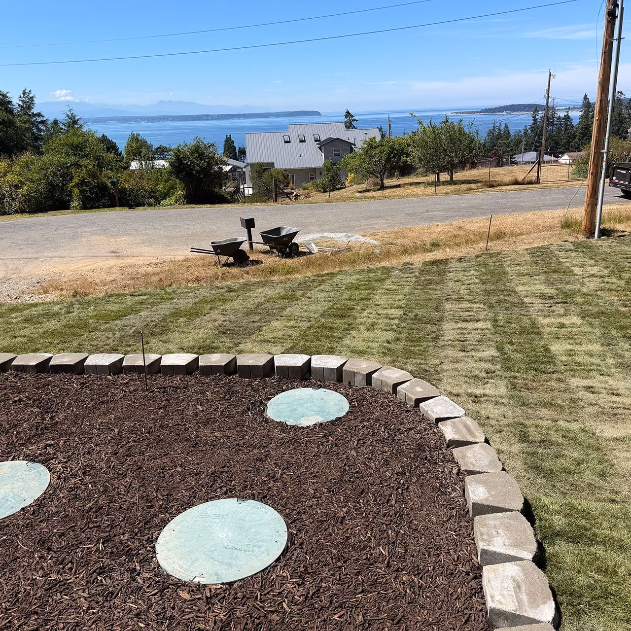 Fresh mulch installation in Oak Harbor, Washington by Ebai’s Landscaping for clean, well-maintained landscape beds