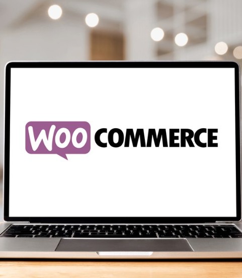 Laptop screen displaying the WooCommerce logo, representing e-commerce marketplace integration for automated order fulfillment services.