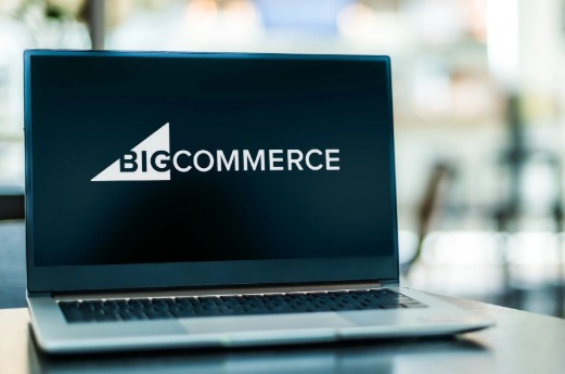 Laptop screen displaying the BigCommerce logo on a dark background, representing enterprise e-commerce platform integration for automated order fulfillment services.