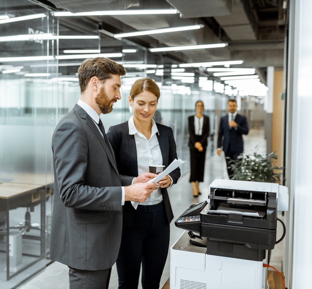 image of people standing next to copier