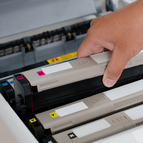 A person changing out a toner cartridge