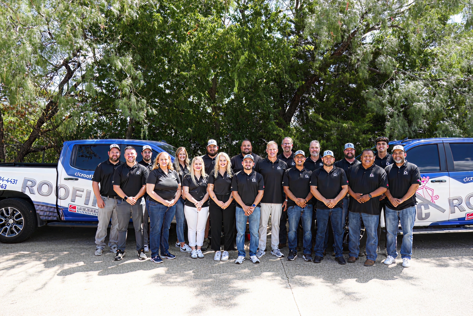 CLC Roofing team standing in front of branded company trucks in Southlake TX