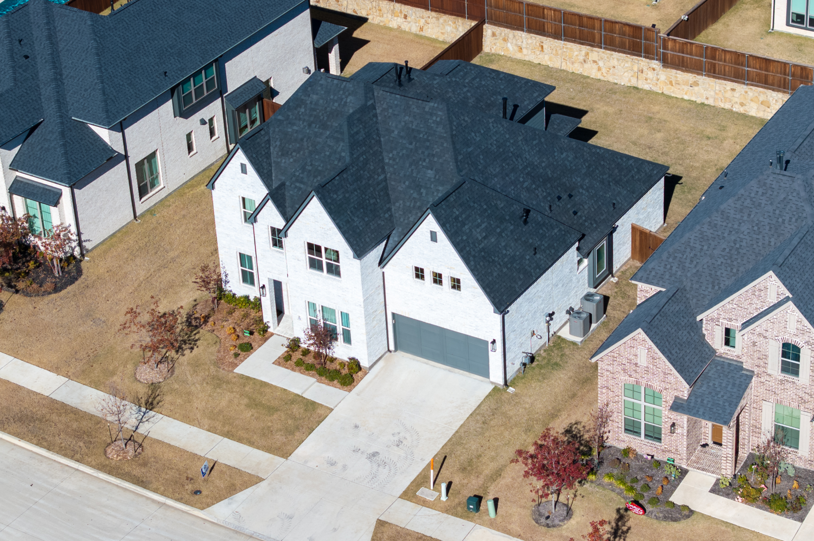 Front view of brick and stone home with new asphalt shingle roof in Southlake TX