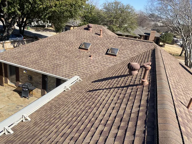 Aerial view of residential home with brown shingle roof after hail damage inspection in Southlake TX