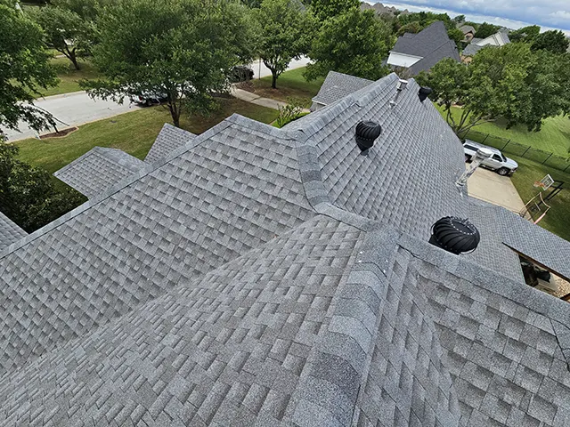 Aerial view of newly installed gray asphalt shingle roof on a residential home by CLC Roofing in Southlake, TX.