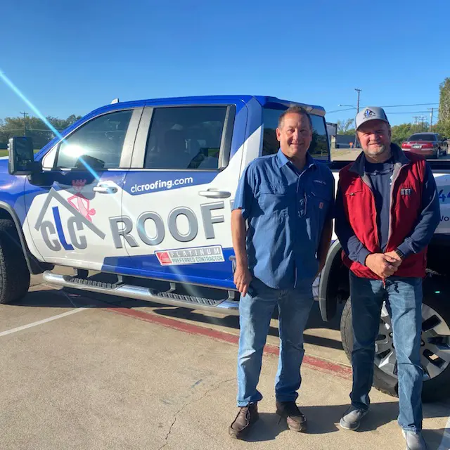 CLC Roofing team members standing in front of a company truck in Southlake, TX, specializing in stone-coated steel roofing installations.