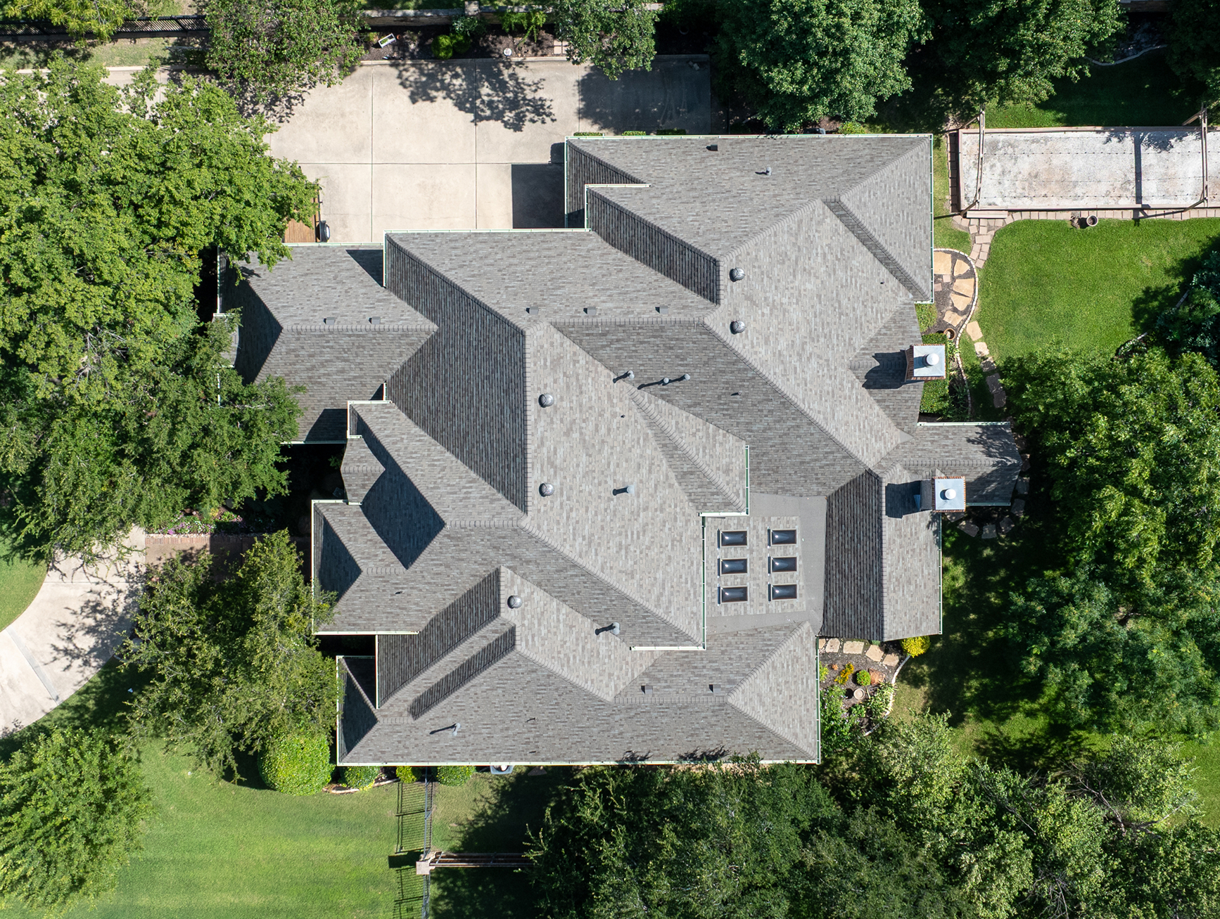 Aerial view of completed residential roof installation with asphalt shingles in Southlake TX