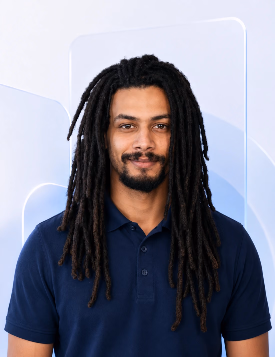 Professional Nimbus Media team profile portrait of Todd wearing a navy polo shirt against a soft pale blue glassmorphism background.