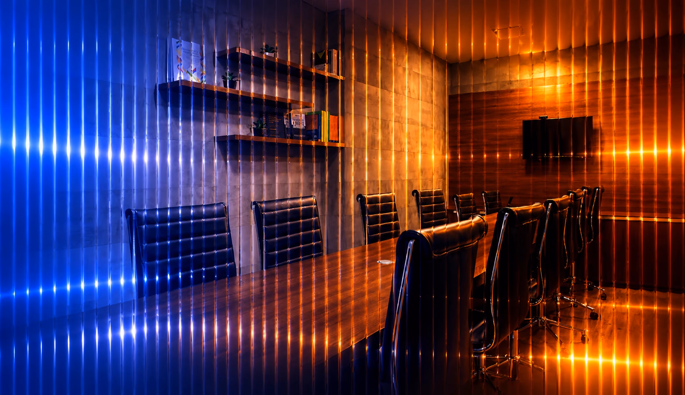 Fluted glass professional services graphic showing a modern conference room with blue and amber lighting, reflective glass distortion, and cinematic light streaks.