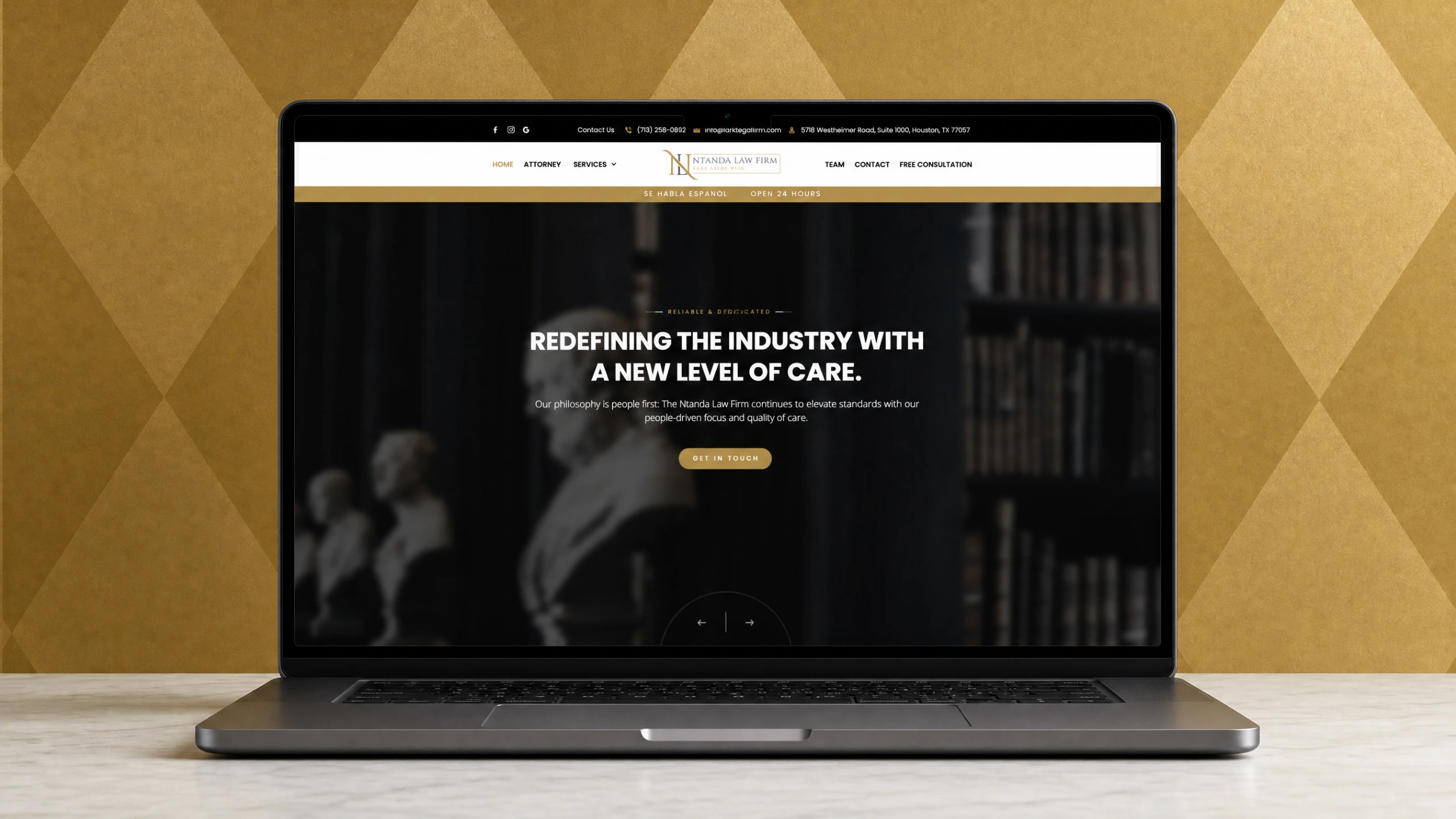 Ntanda Law Firm brand identity on a laptop with antique-gold backdrop