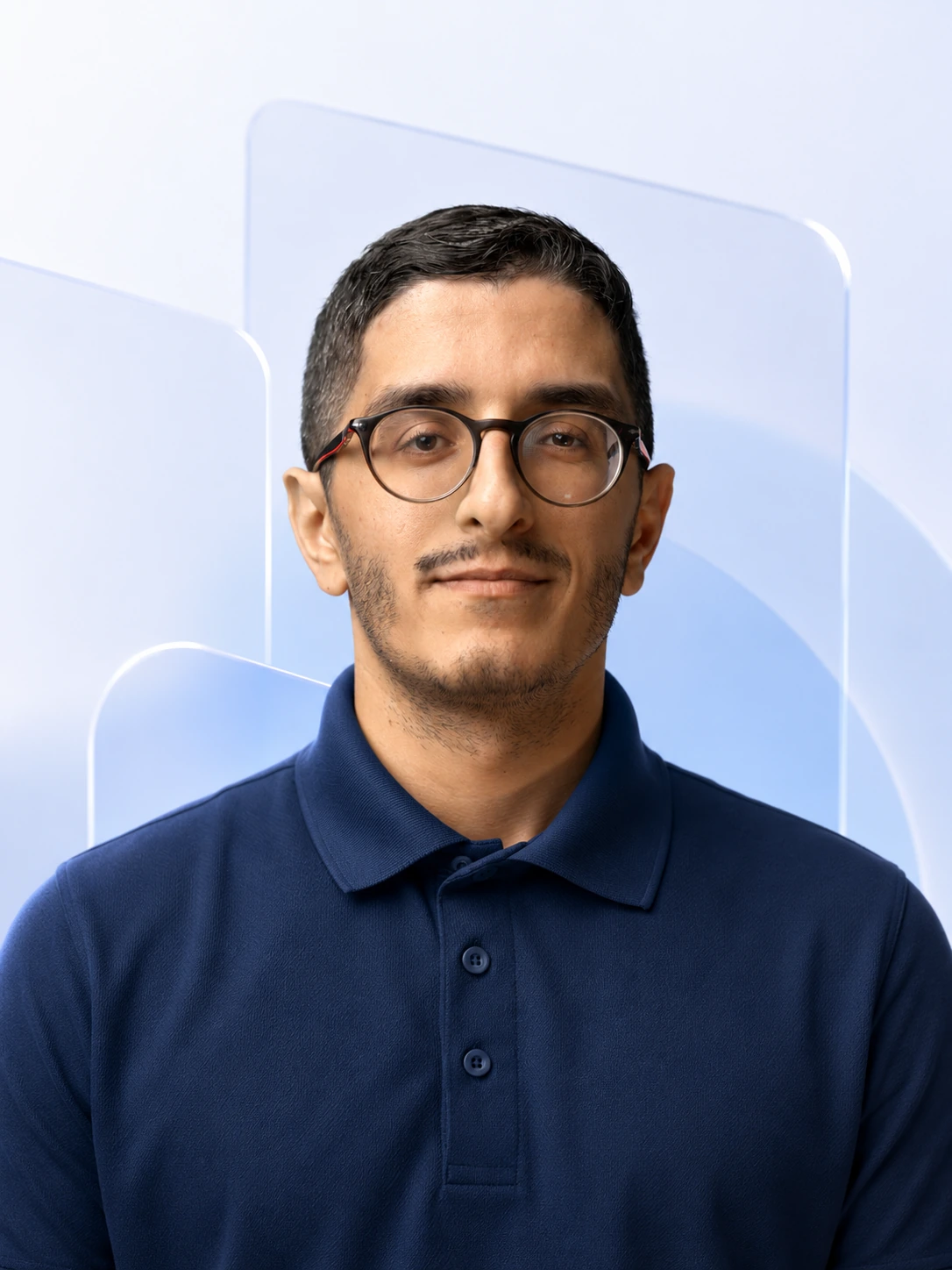 Nimbus Media team portrait in a navy polo against a pale fluted glass backdrop