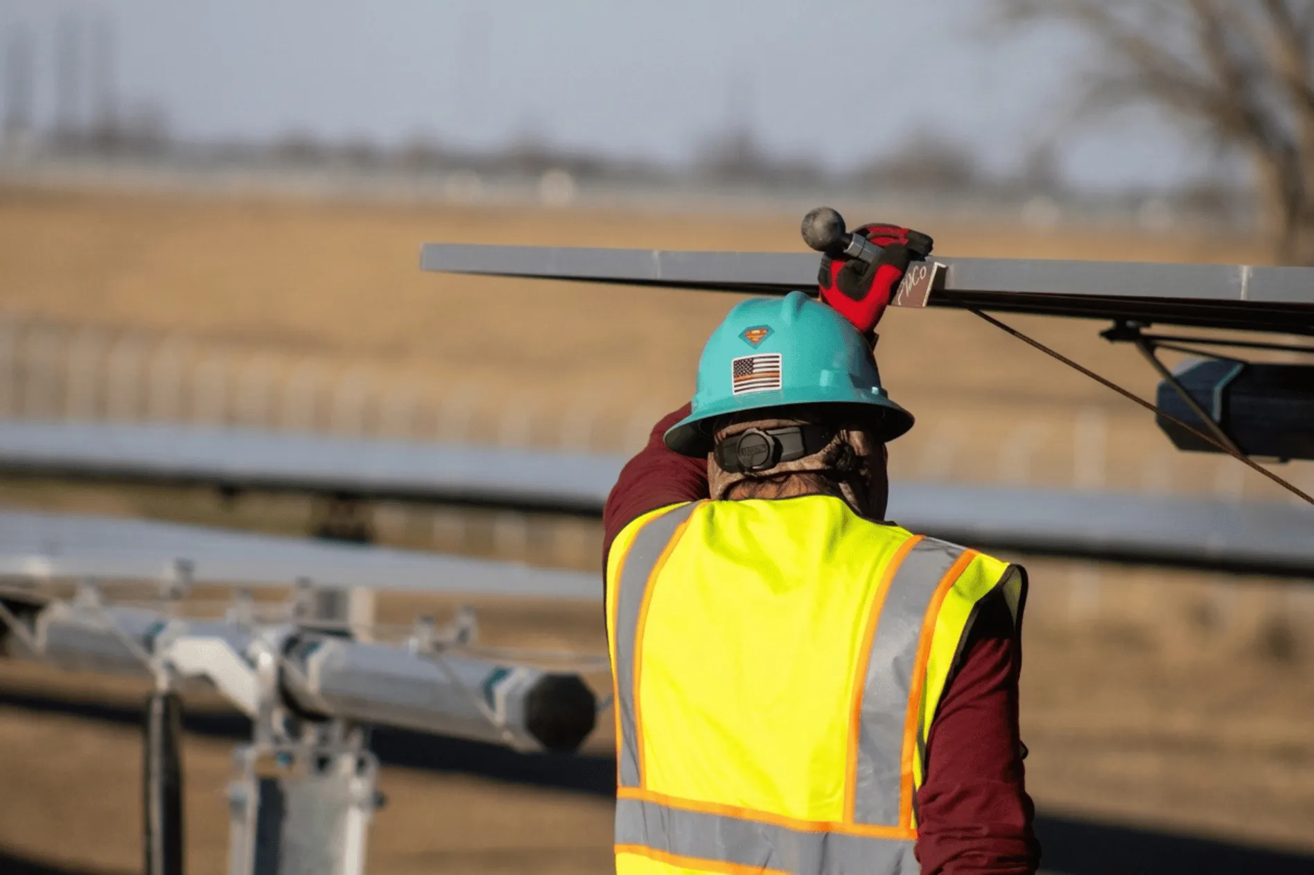 Crew member installing equipment on a job site