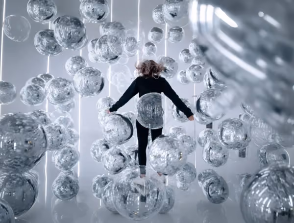 Woman playing inside the Invisible Ballet room at Balloon Museum