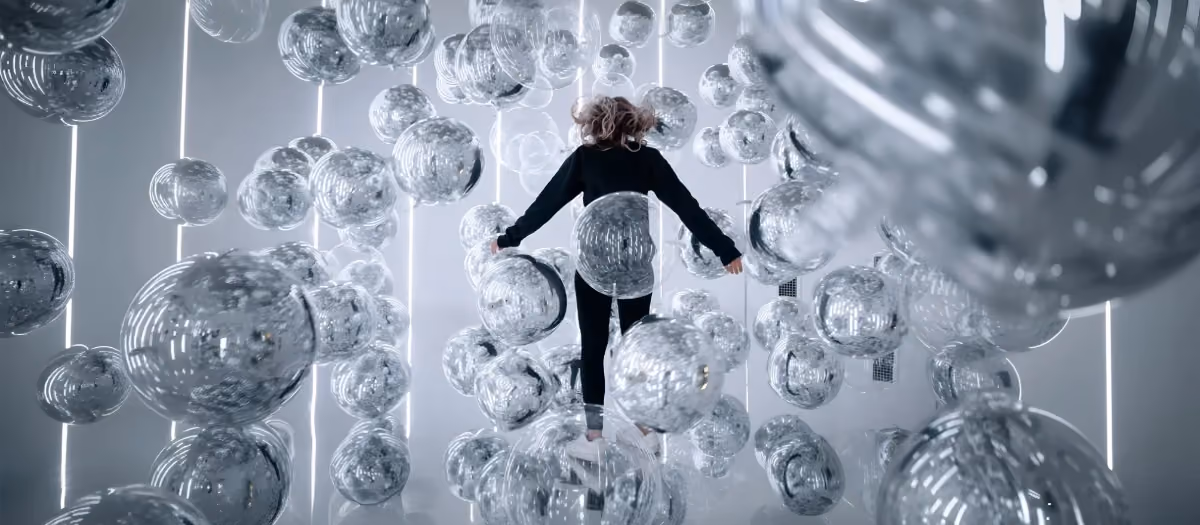Woman playing inside the Invisible Ballet room at Balloon Museum