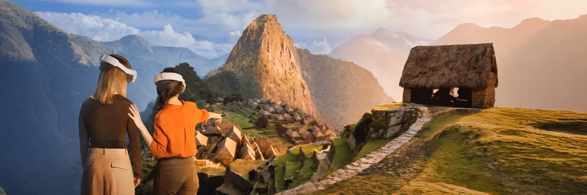 Two visitors wearing VR headsets look out over a virtual reconstruction of Machu Picchu and its peak.