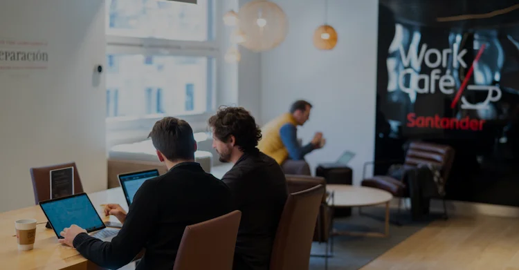 Two people working on laptops at one of Santander's Work Cafés in Madrid.