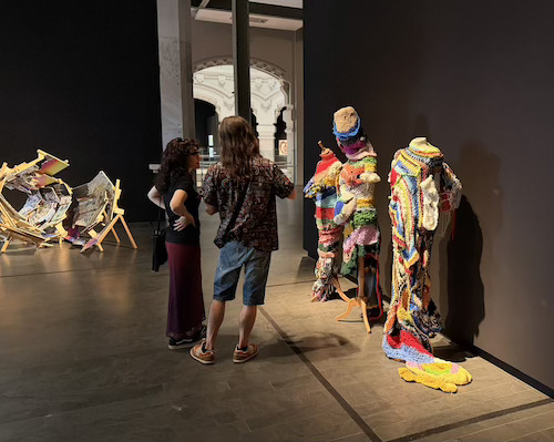 Two visitors viewing artwork at Fundación ONCE's Art Biennial: The Illusion Charm, Madrid