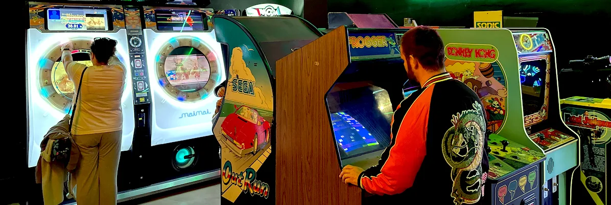 Guests enjoying classic arcade cabinets and rhythm games inside OXO Museo Madrid in Madrid
