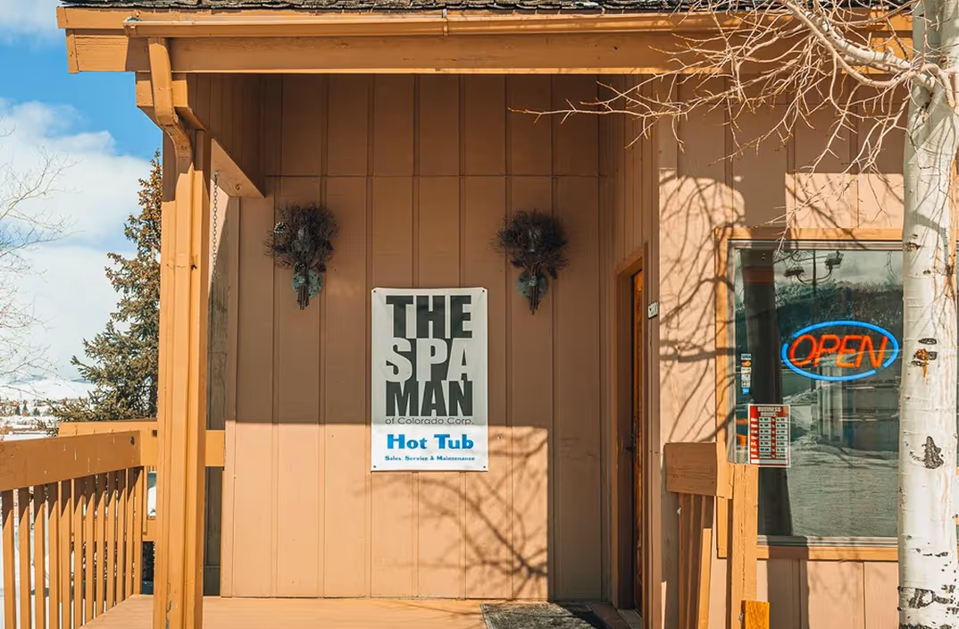 The front of The Spa Man retail location, featuring the company logo on a sign at the entrance.
