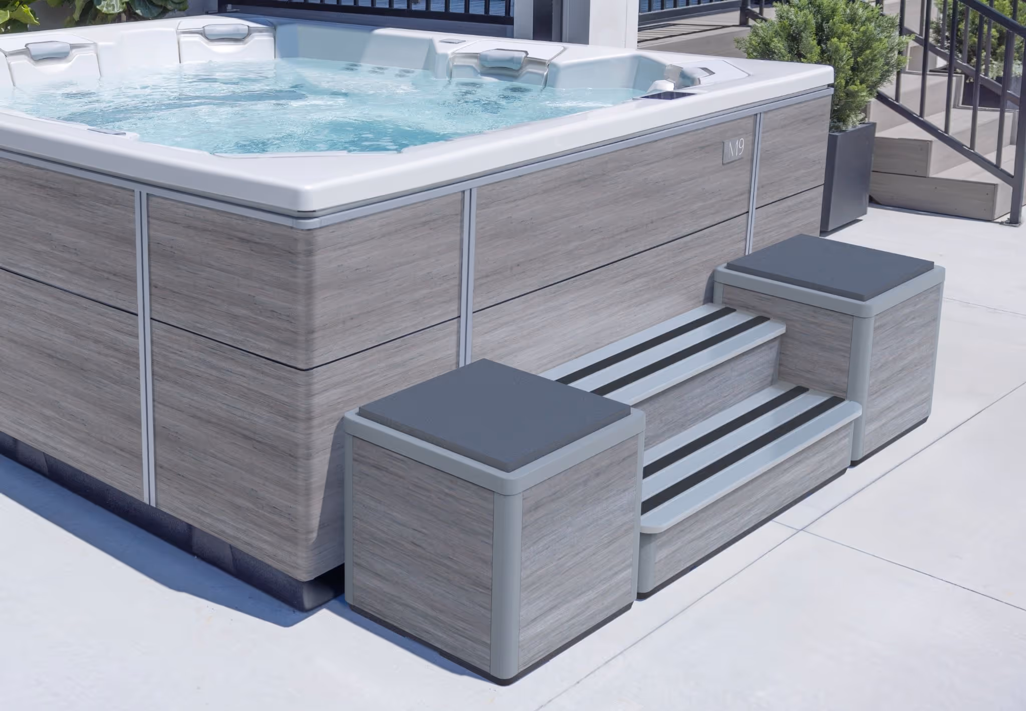 An M series spa tub with color-matched steps leading up to it.