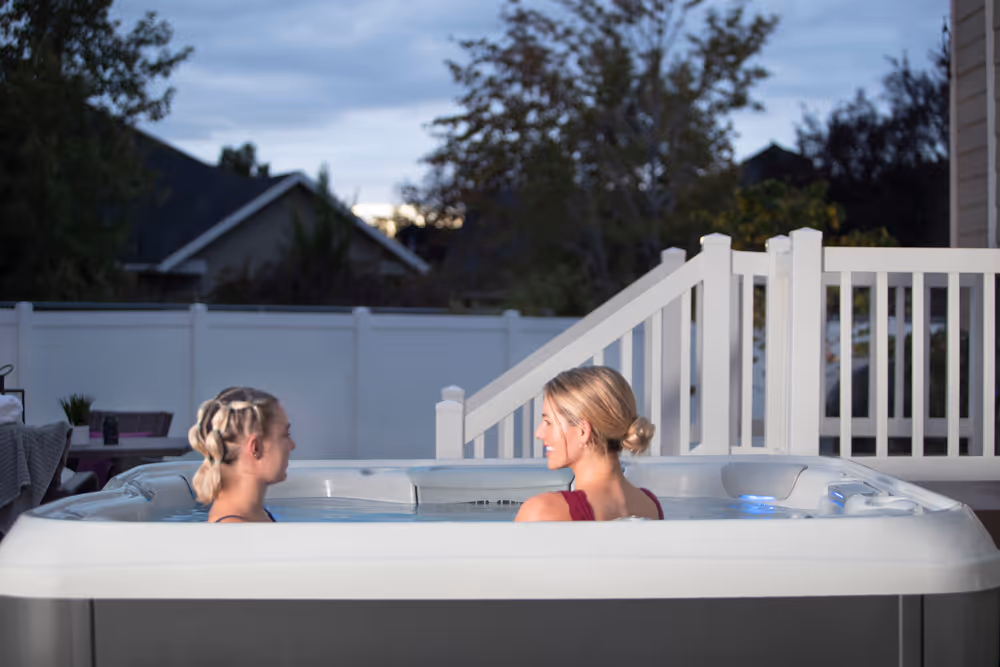 Two women sitting and enjoying an X Series spa.