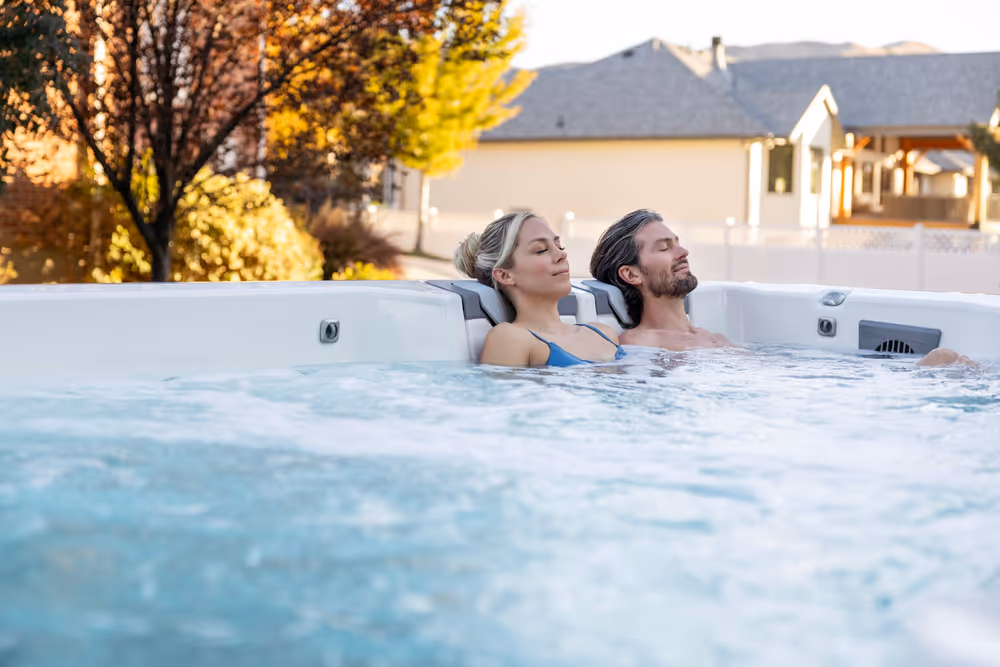 Two people sitting and relaxing in a Swim series spa.