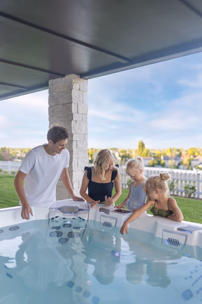 A family of four examining the M7 spa's seating area.