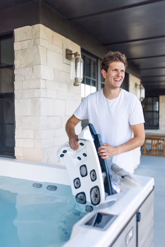 A man removing a Jetpak seat from an M series spa.