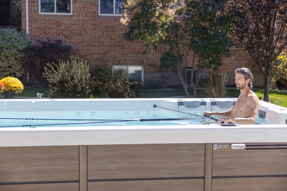 A man exercising with the Swim series spa.