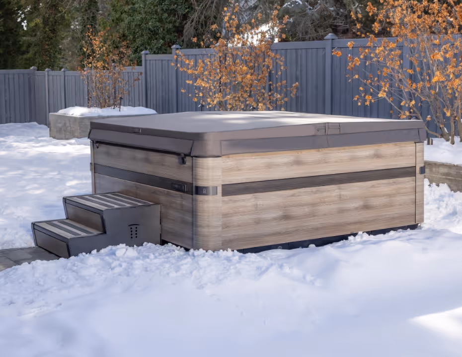 A Series spa with snow-covered cover outdoors in winter.