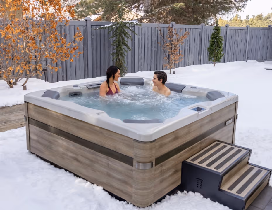 A mother and son enjoying an A Series spa together in winter.